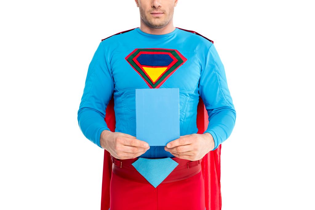 cropped shot of man in superhero costume holding blank box with soap powder isolated on white - Photo, Image