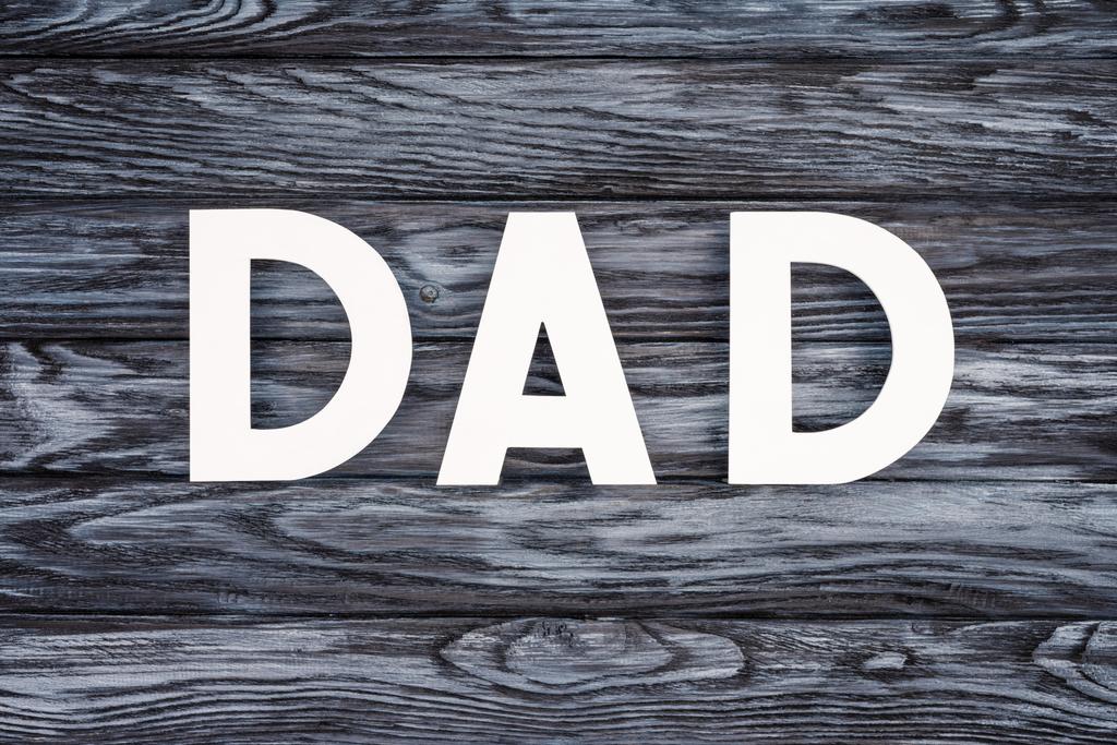 top view of DAD lettering on grey wooden tabletop, Happy fathers day concept - Photo, Image
