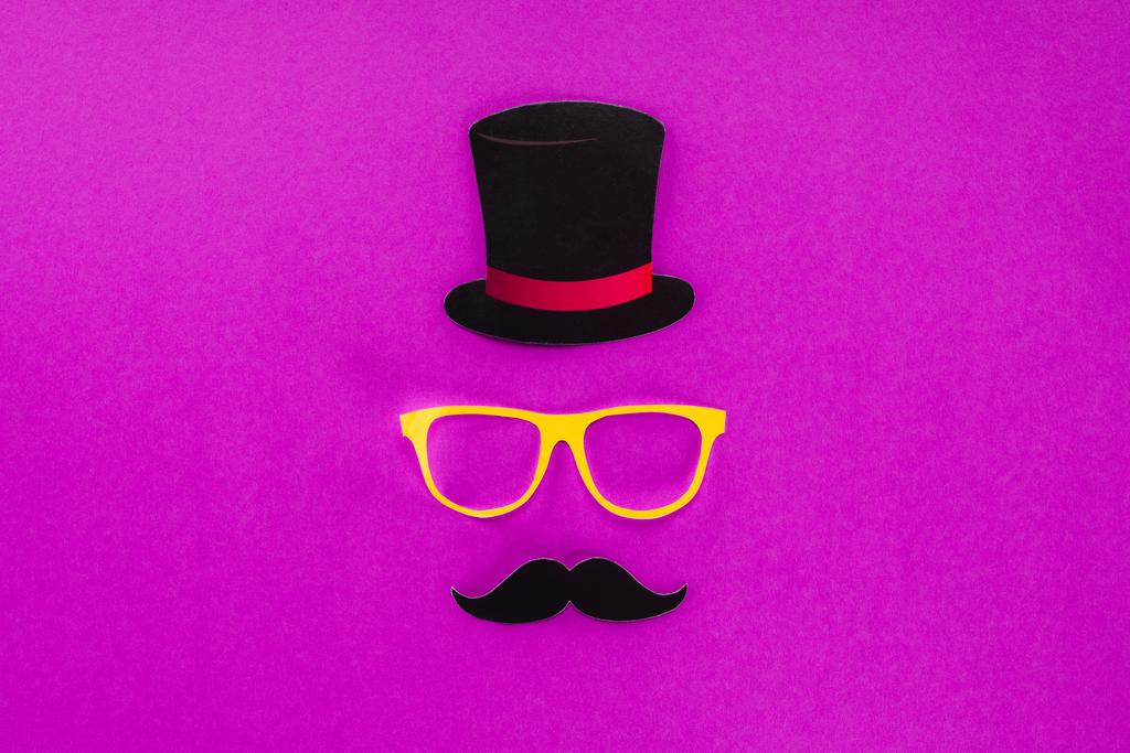 top view of gentleman face made of cardboard eyeglasses, mustache and hat on pink surface - Photo, Image