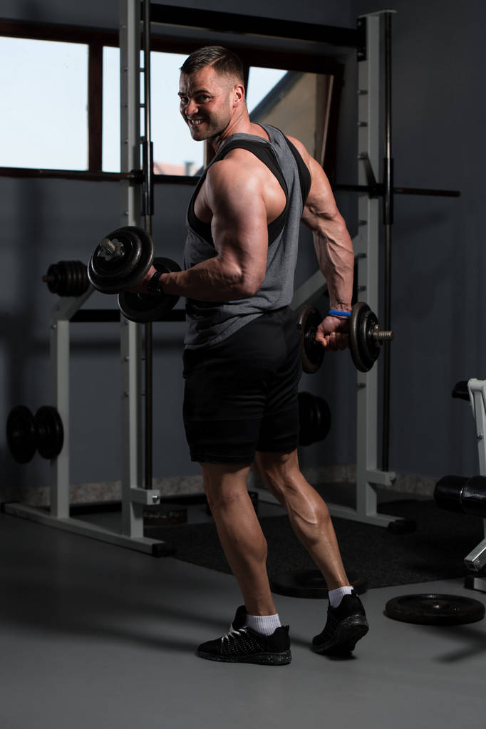 Man Working Out Biceps In A Gym - Dumbbell Concentration Curls - Photo, Image