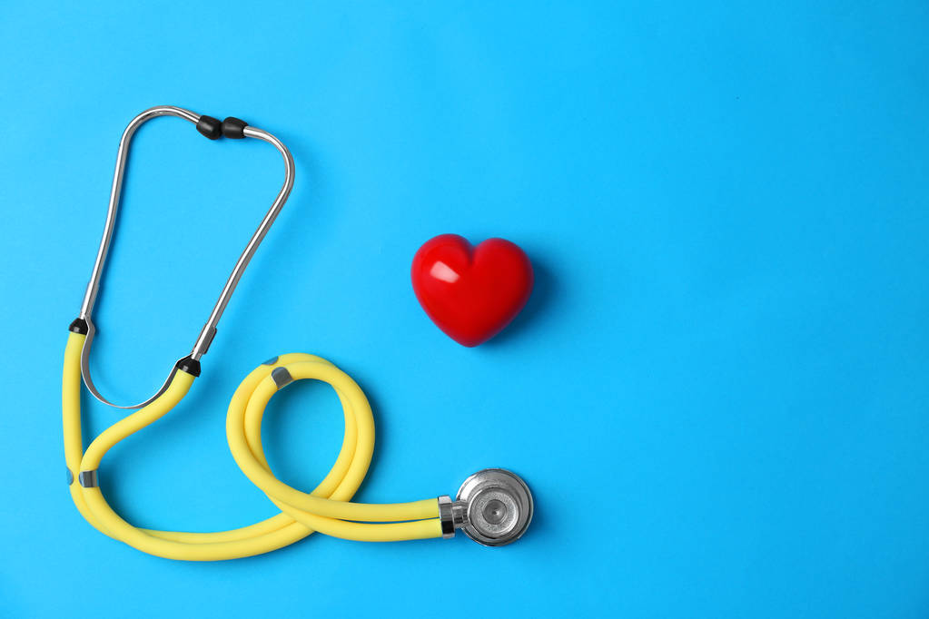 Stethoscope and heart model on color background, top view. Medical equipment - Photo, Image