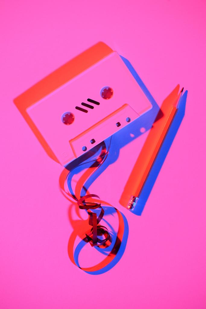 toned pink picture of retro audio cassette with pencil and tape - Photo, Image