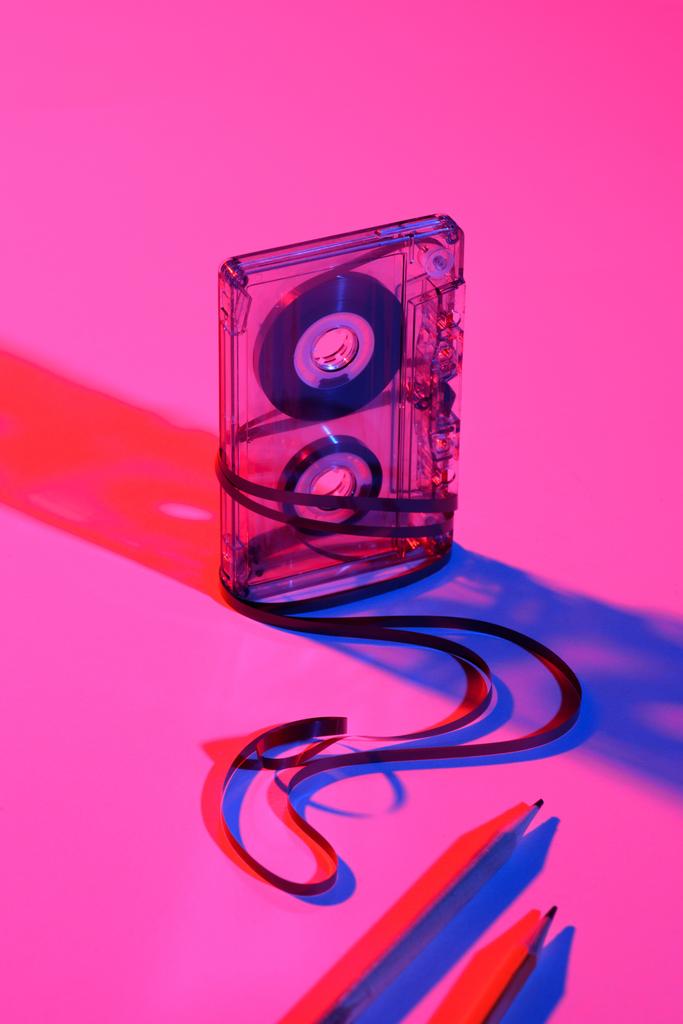 close up view of retro audio cassette and pencils on pink backdrop - Photo, Image