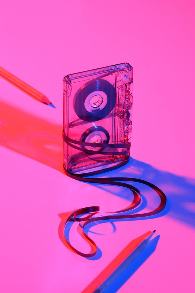 close up view of retro audio cassette and pencils on pink backdrop - Photo, Image