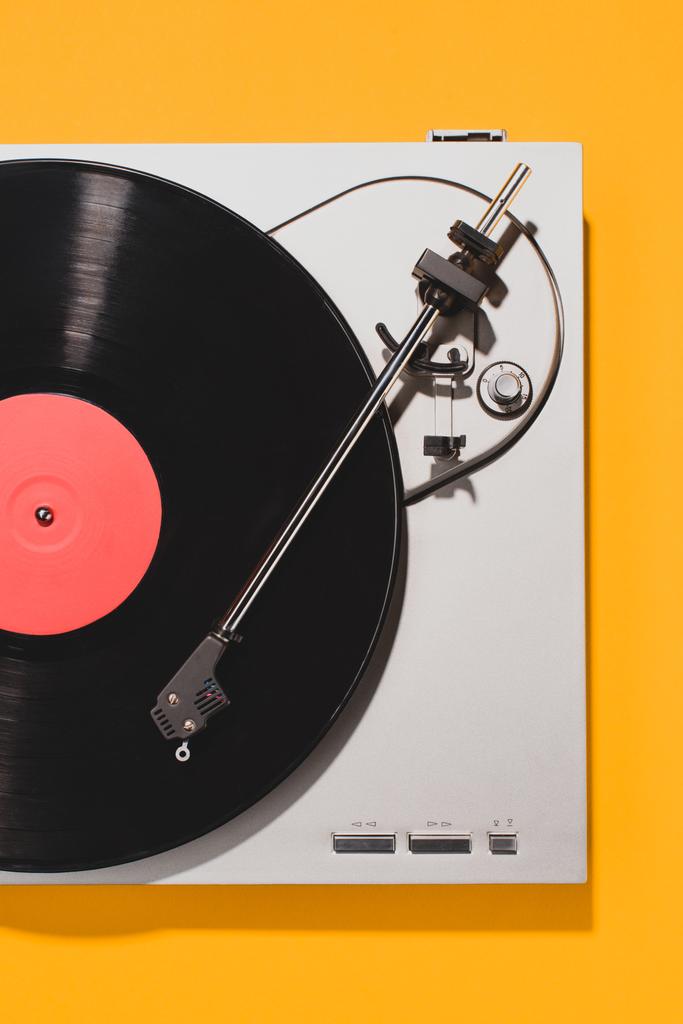 top view of retro vinyl player and record isolated on yellow - Photo, Image