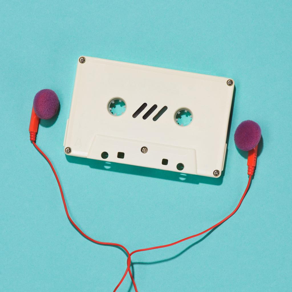 flat lay with white retro audio cassette and earphones isolated on blue - Photo, Image
