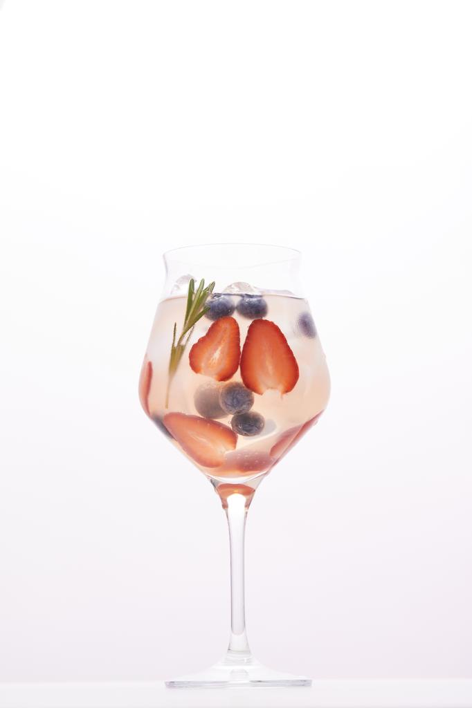 glass of lemonade with rosemary, blueberries and strawberries isolated on white background  - Photo, Image