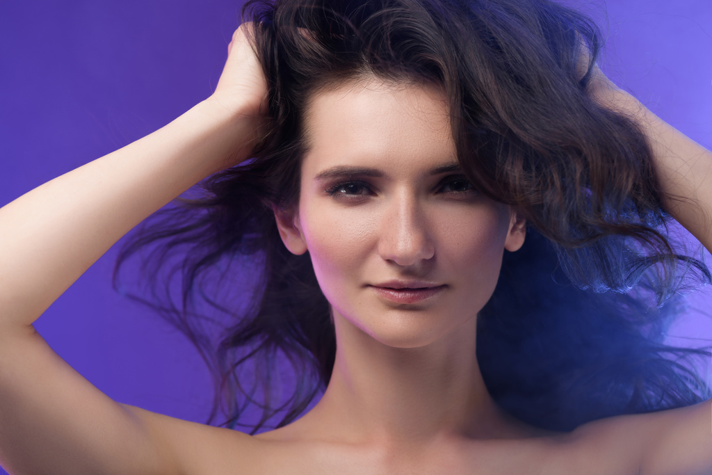 portrait of young beautiful brunette woman on purple  - Photo, Image