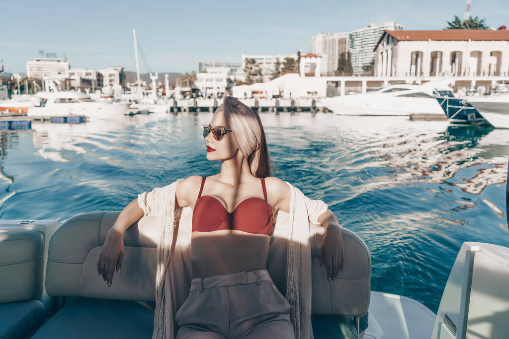 mooie luxe meisje ligt in een boot, geniet van zeereis en vakantie - Foto, afbeelding
