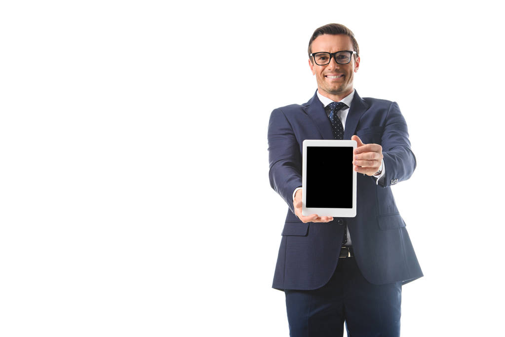 smiling businessman in eyeglasses holding digital tablet with blank screen isolated on white background  - Photo, Image