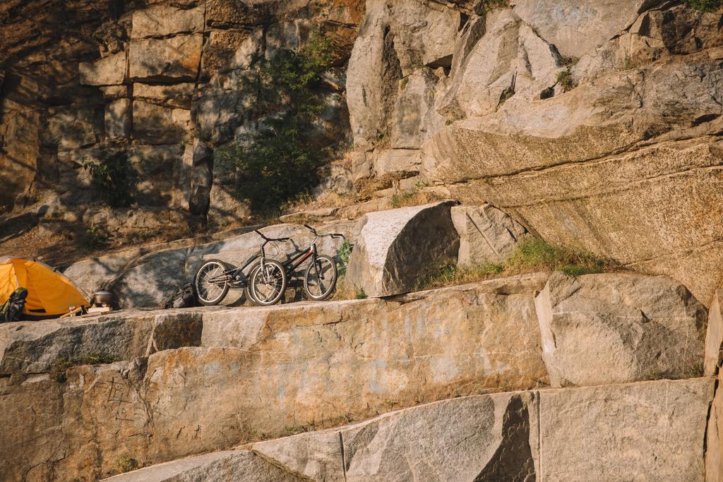 風光明媚な岩の崖上旅行テント近くのマウンテン バイク観  - 写真・画像