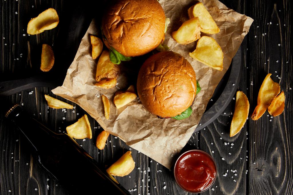 Set of junk food hamburgers and fried potatoes on craft paper - Photo, Image