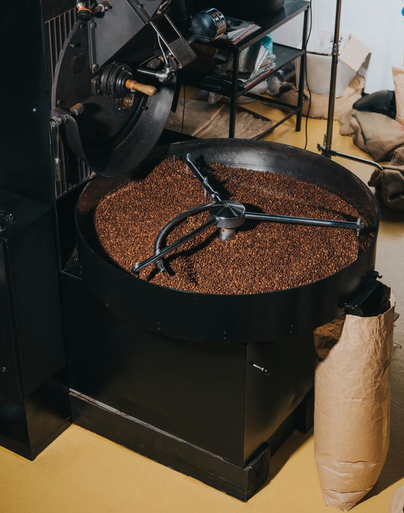 Industrial coffee roaster with large paper bags filled with coffee beans - Photo, Image