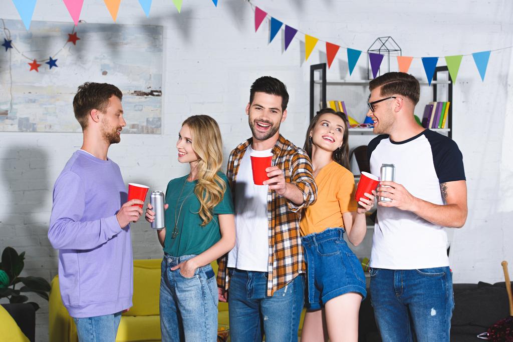 Happy mladí přátelé pití piva zároveň baví spolu doma párty - Fotografie, Obrázek
