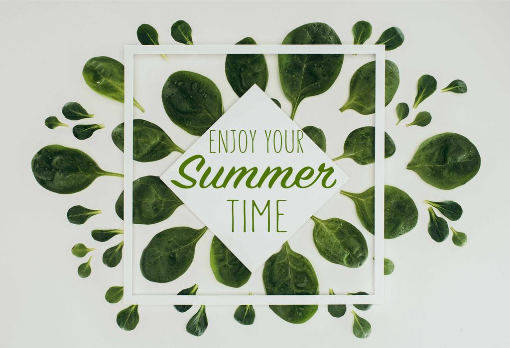 top view of beautiful fresh green leaves with words enjoy your summer time on grey - Photo, Image