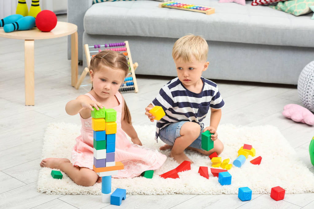Cute children playing with constructor on floor at home - Photo, Image