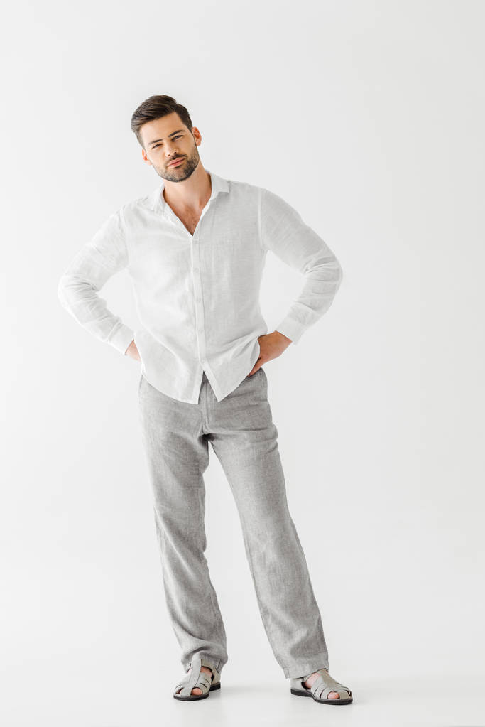 young handsome man in linen clothes standing akimbo isolated on grey background  - Photo, Image