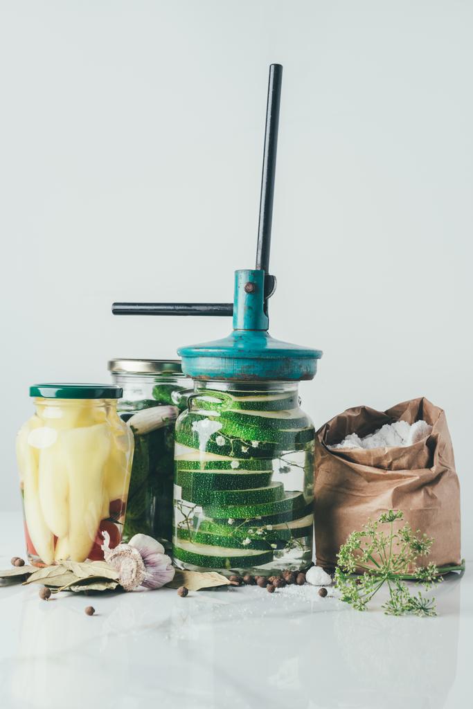 ингредиенты и инструмент для приготовления консервированных овощей на кухонном столе
 - Фото, изображение
