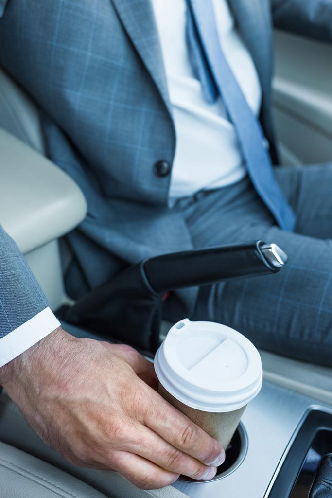 Schnappschuss von Geschäftsmann beim Kaffee-to-go im Auto - Foto, Bild