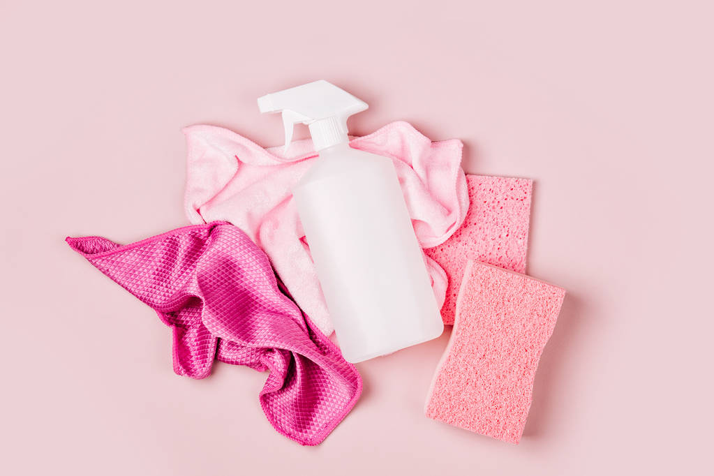 Detergents and cleaning accessories  in pink color.  Cleaning service concept. Flat lay, Top view. - Photo, Image