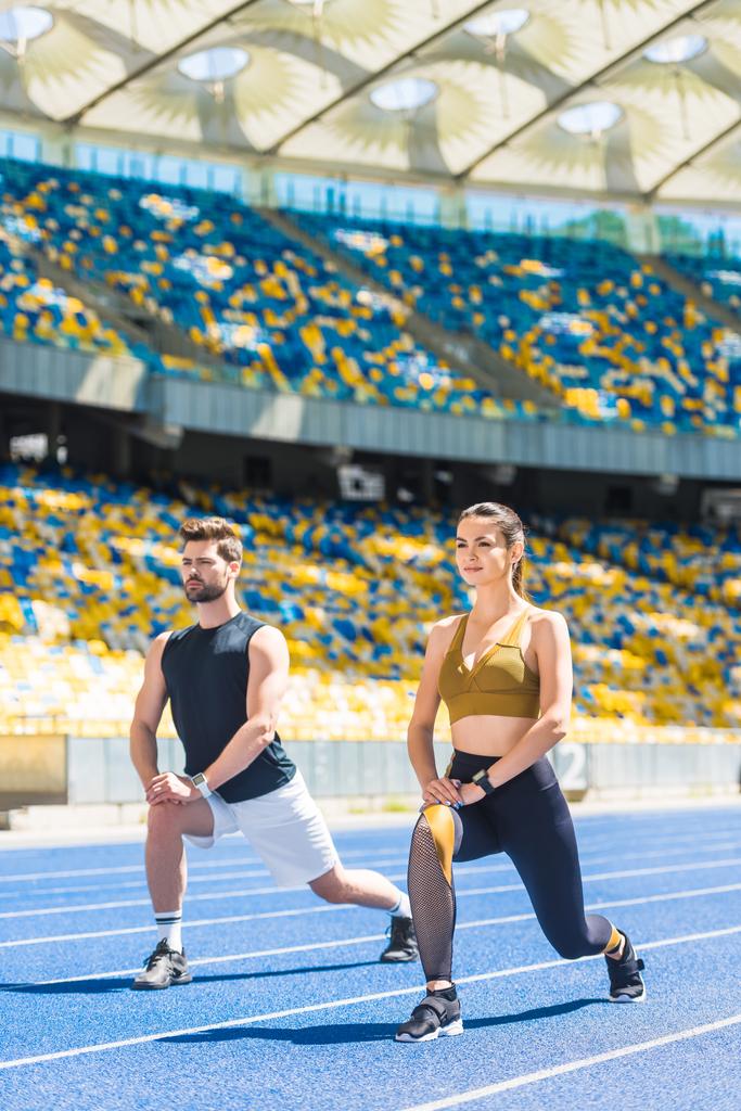 jeune couple athlétique échauffement avant l'entraînement sur piste de course au stade de sport
 - Photo, image