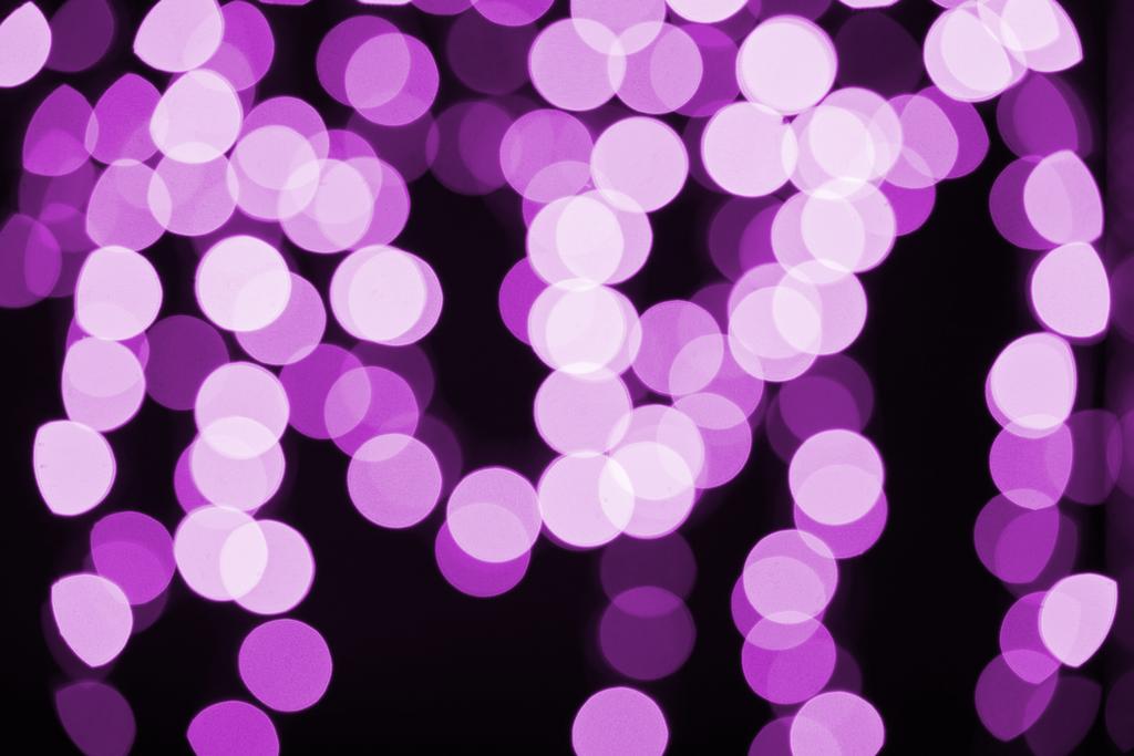 beautiful shiny purple defocused bokeh on black background - Photo, Image