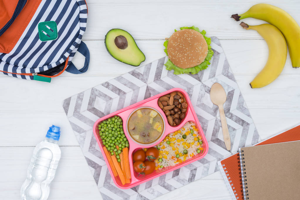 top view of tray with kids lunch for school and copybooks on wooden table - Photo, Image