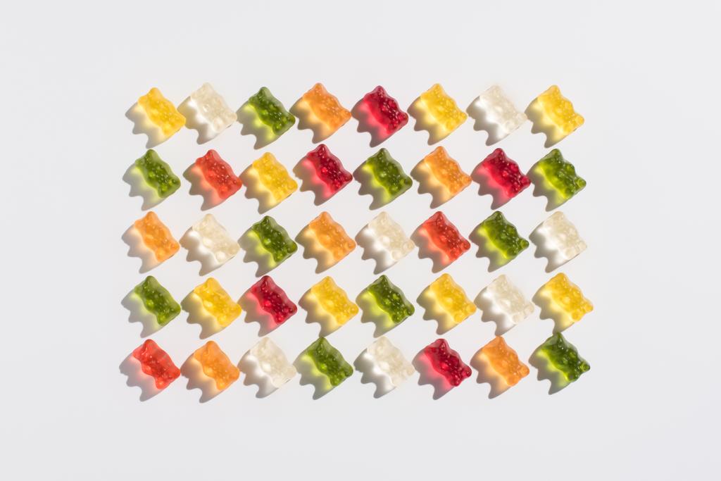 top view of colorful gummy bears pattern on white - Photo, Image
