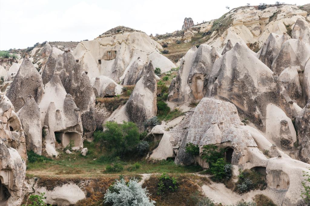 beautiful landscape with famous caves and rock formations in goreme national park, cappadocia, turkey - Photo, Image