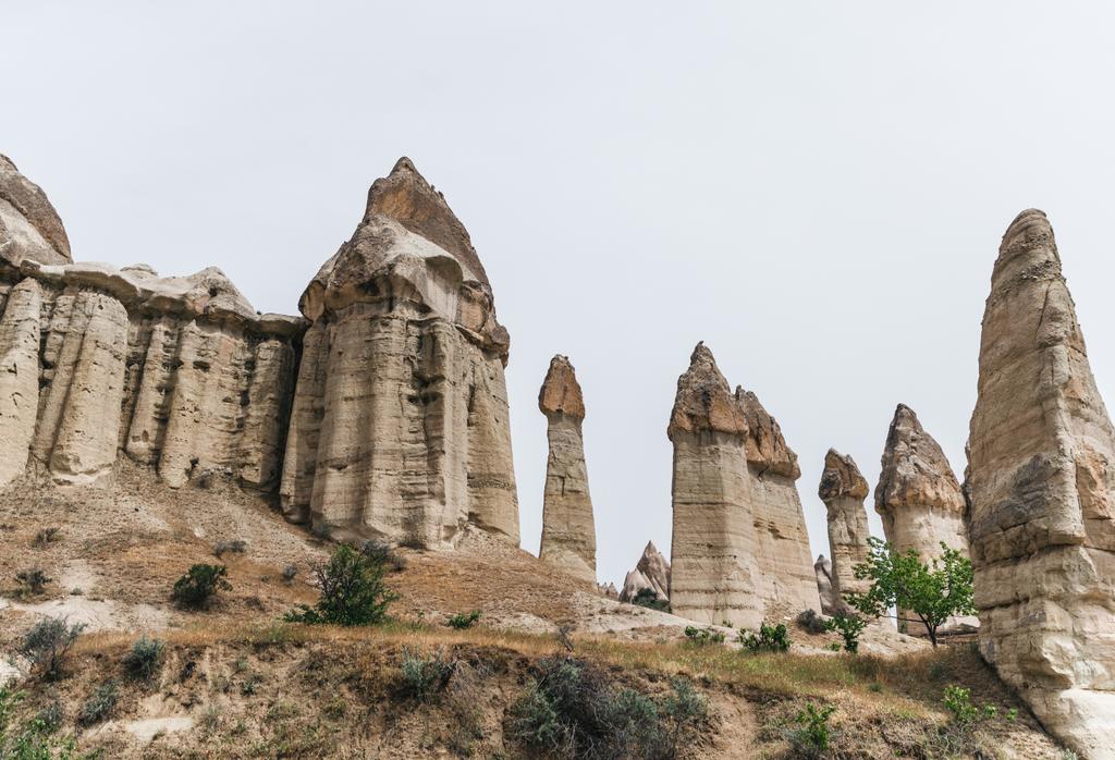 壮大な奇岩で有名なカッパドキア、トルコの曇り空を背景  - 写真・画像
