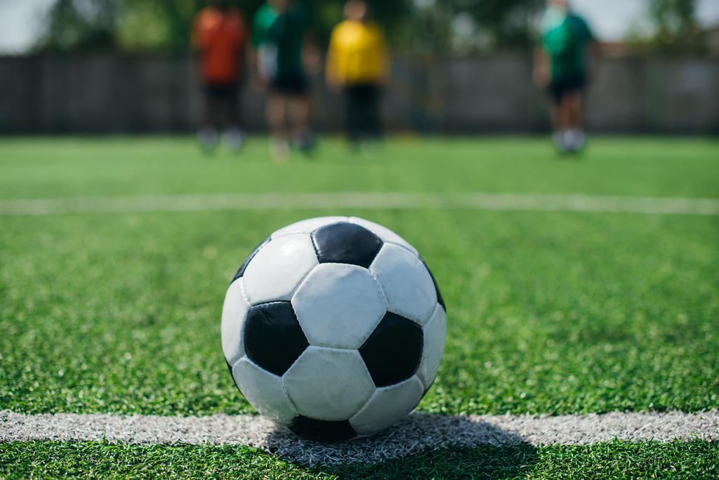 futbol topu ve yeşil saha oyuncu seçici odak - Fotoğraf, Görsel