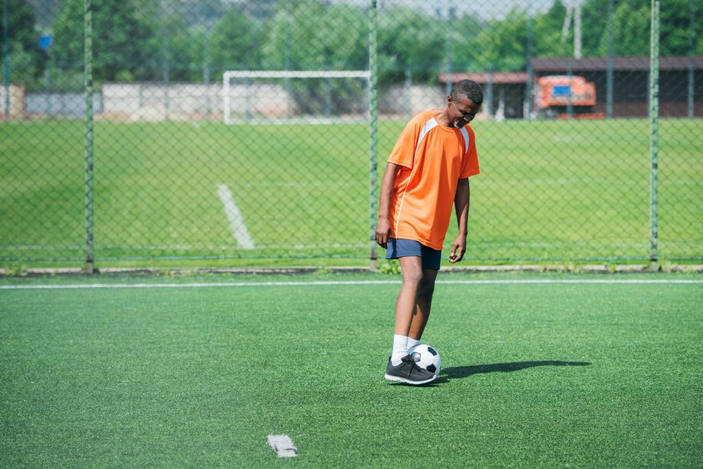african american elderly man training with football ball in field - Photo, Image