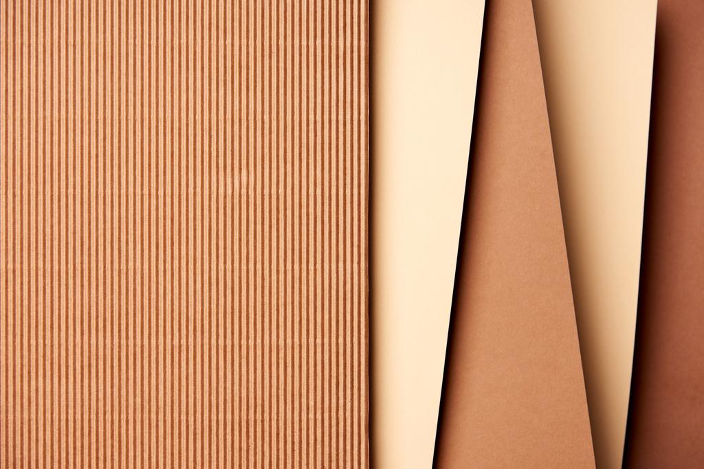 Paper sheets in beige and brown tones background - Photo, Image