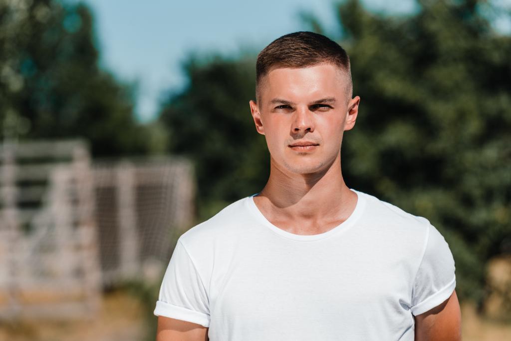 portrait of young soldier in white shirt looking at camera on range - Photo, Image