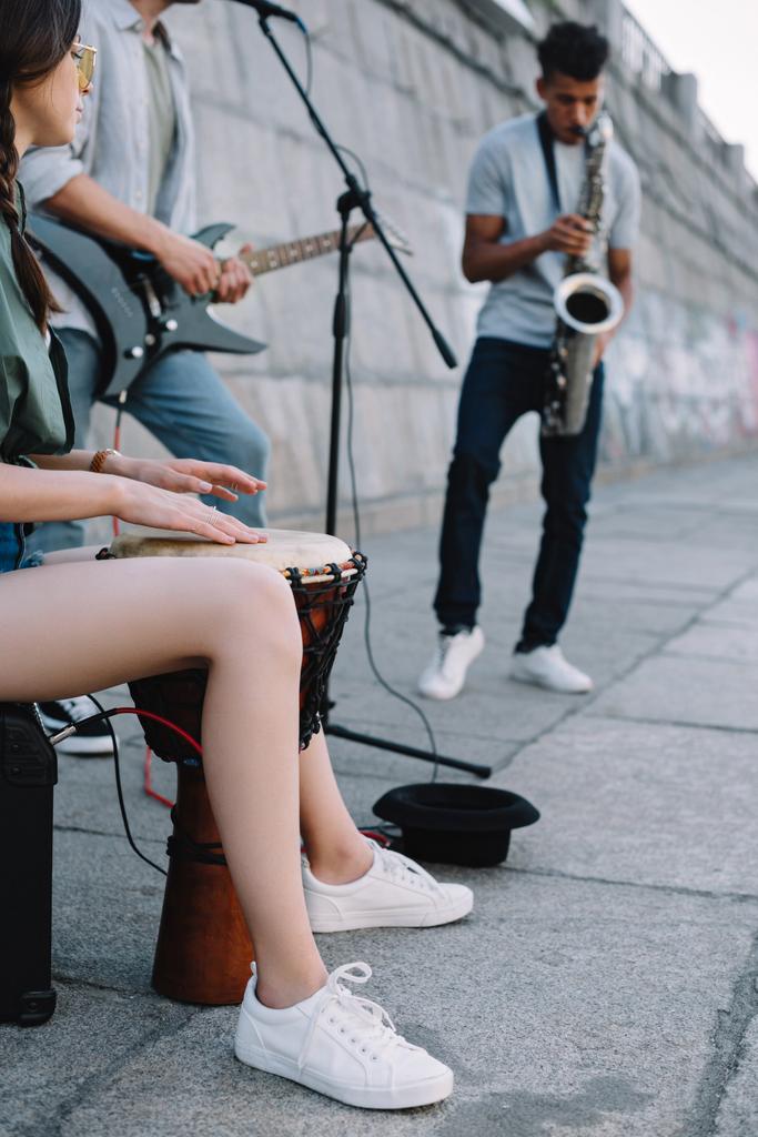 Musiciens de rue talentueux avec guitare, batterie et saxophone en ville
 - Photo, image