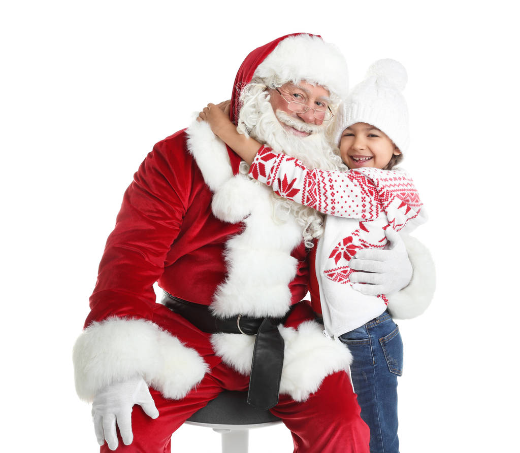 Niña abrazando a Papá Noel auténtico sobre fondo blanco
 - Foto, Imagen