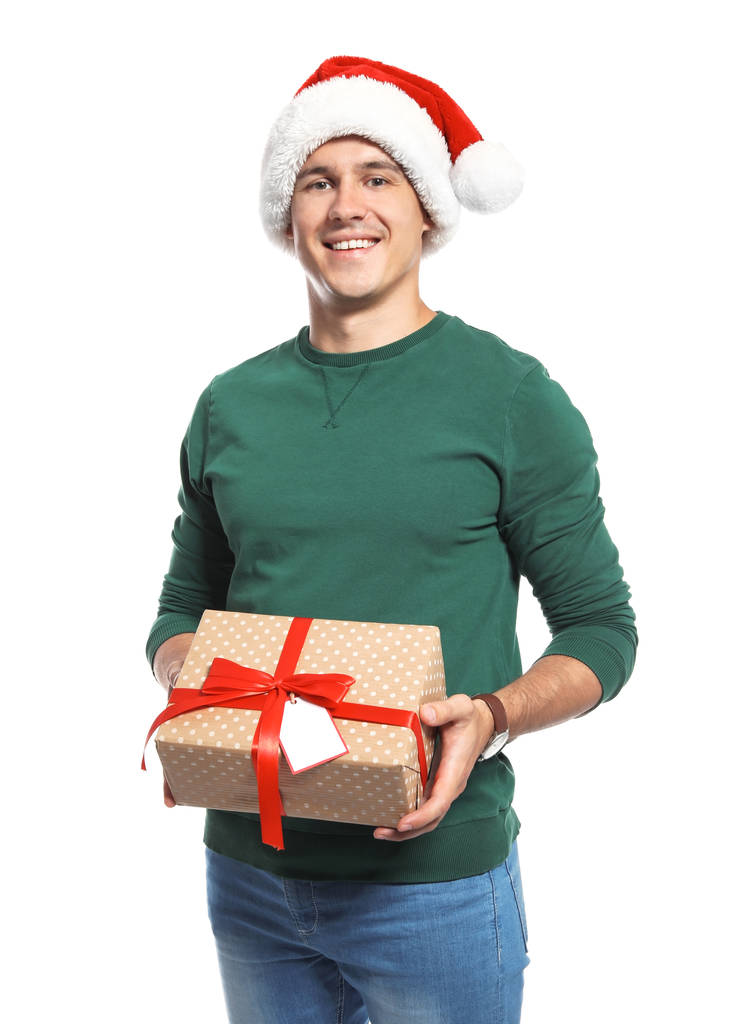 Νεαρός άνδρας με το δώρο Χριστουγέννων σε λευκό φόντο - Φωτογραφία, εικόνα