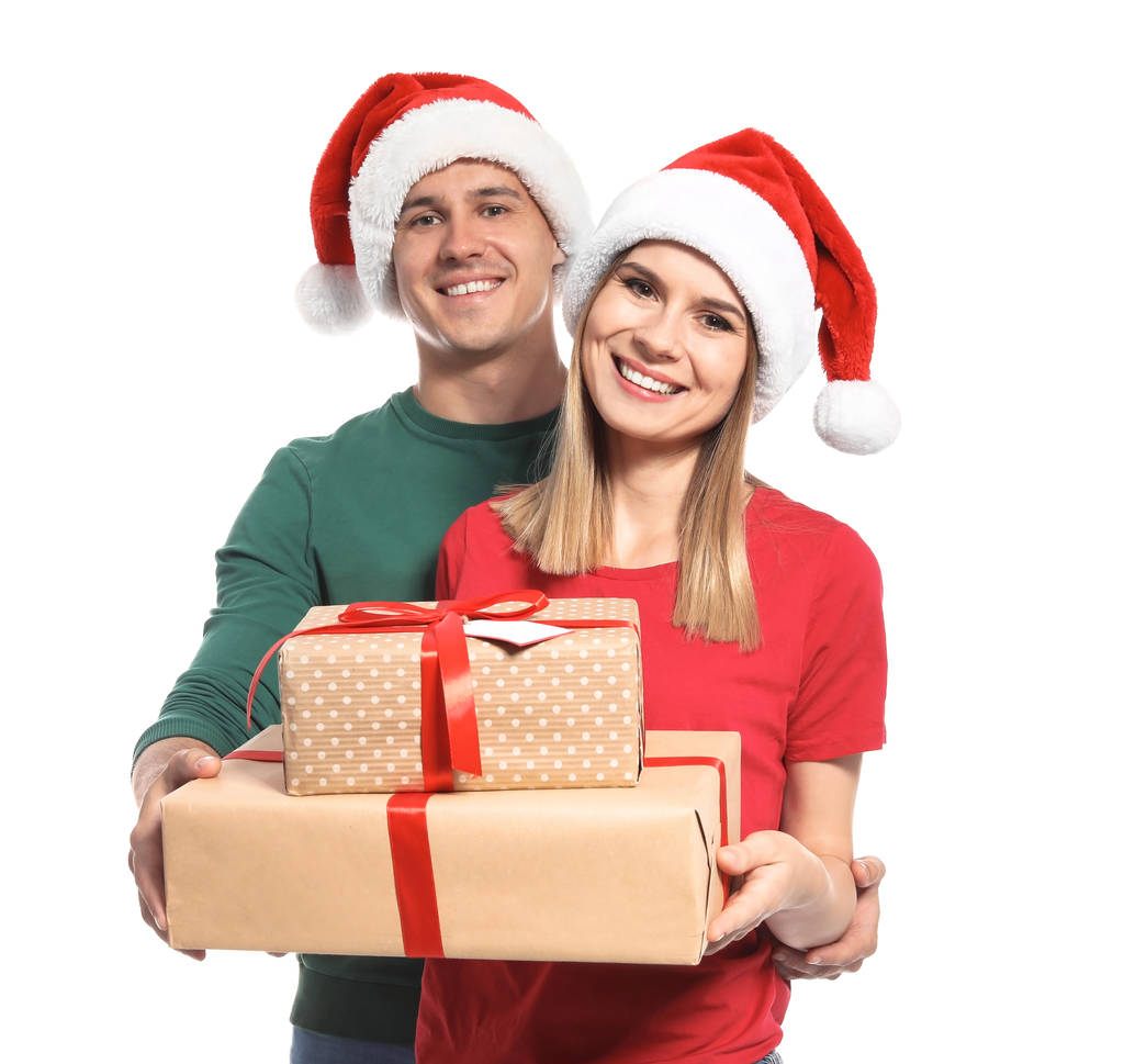 Young couple with Christmas gifts on white background - Photo, Image