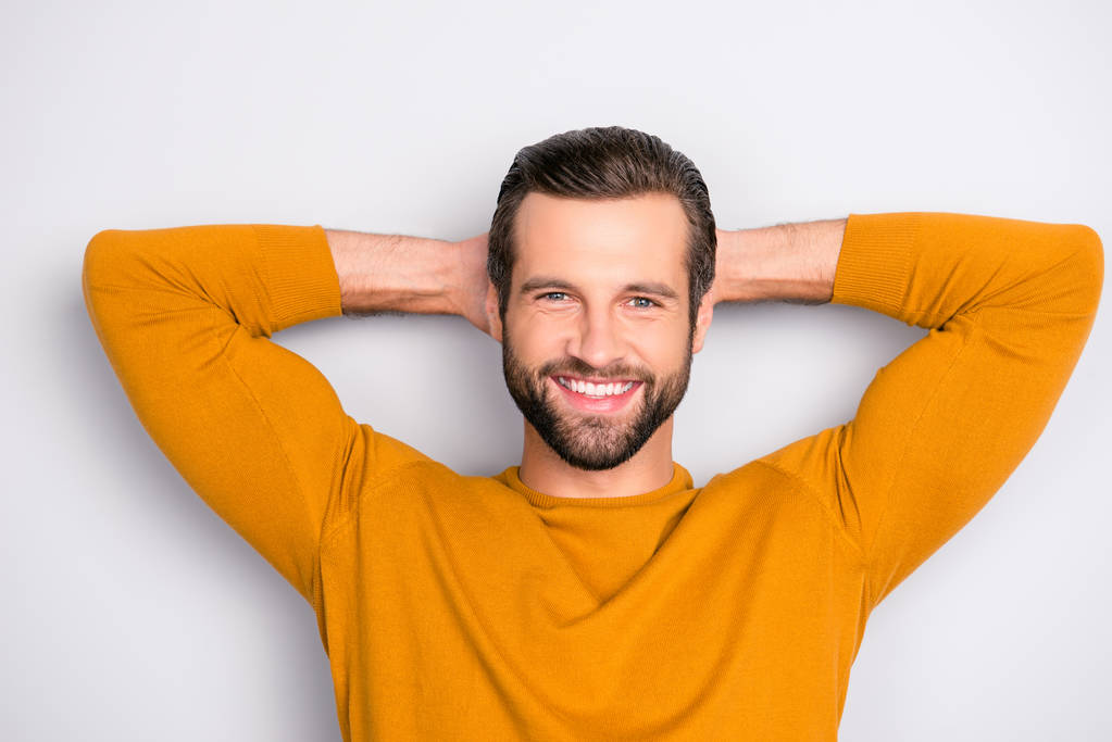 Close up portrait of cheerful excited joyful careless delightful dreamy handsome attractive guy dressed in yellow tight pullover having a rest isolated on gray background - Photo, Image