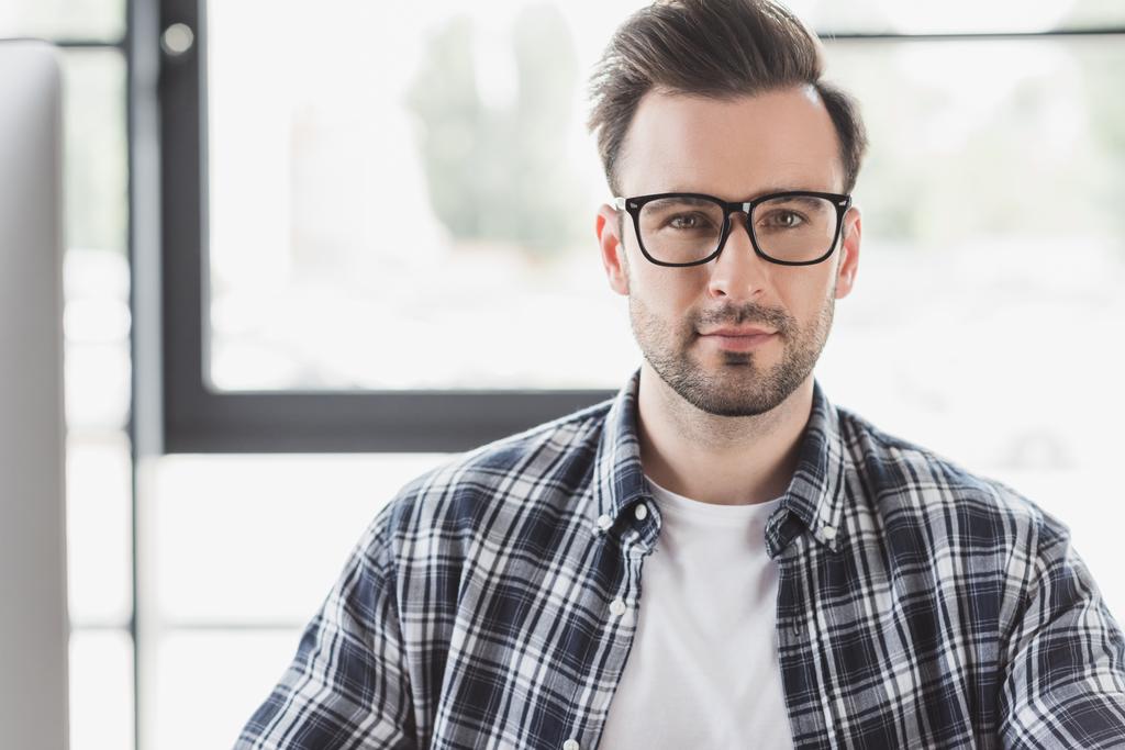 portrait of handsome young man in eyeglasses looking at camera - Photo, Image