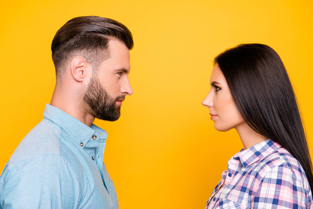 Profile portrait of jealous angry couple standing face to face having problem conflict isolated on vivid yellow background. Psychology concept - Photo, Image