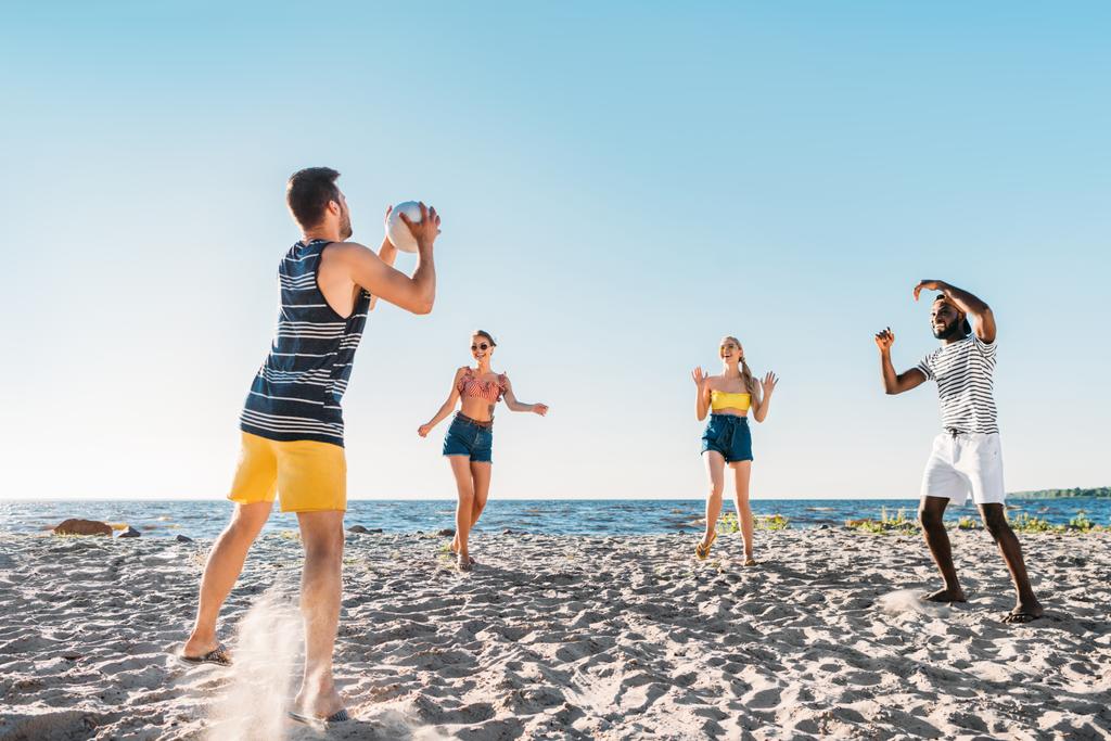 onnellinen nuori monikansallinen ystäviä pelaa rantalentopalloa
  - Valokuva, kuva