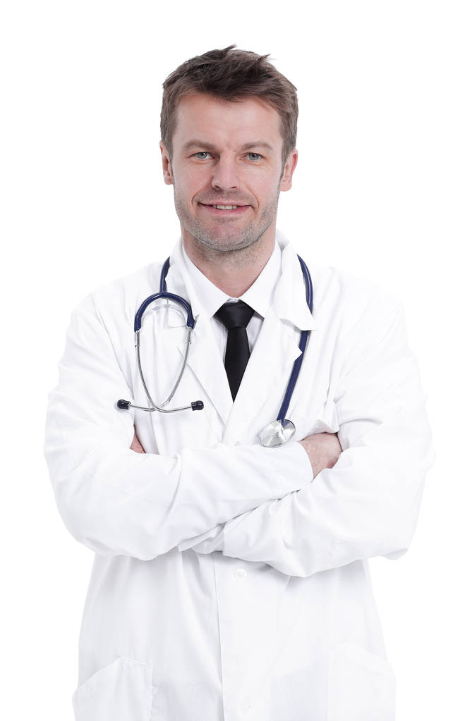 Komea kypsä lääkäri katsoo kameraa seistessään taitettuina käsivarret
 - Valokuva, kuva