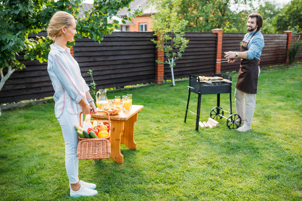 couple having barbecue on backyard on summer day - Photo, Image