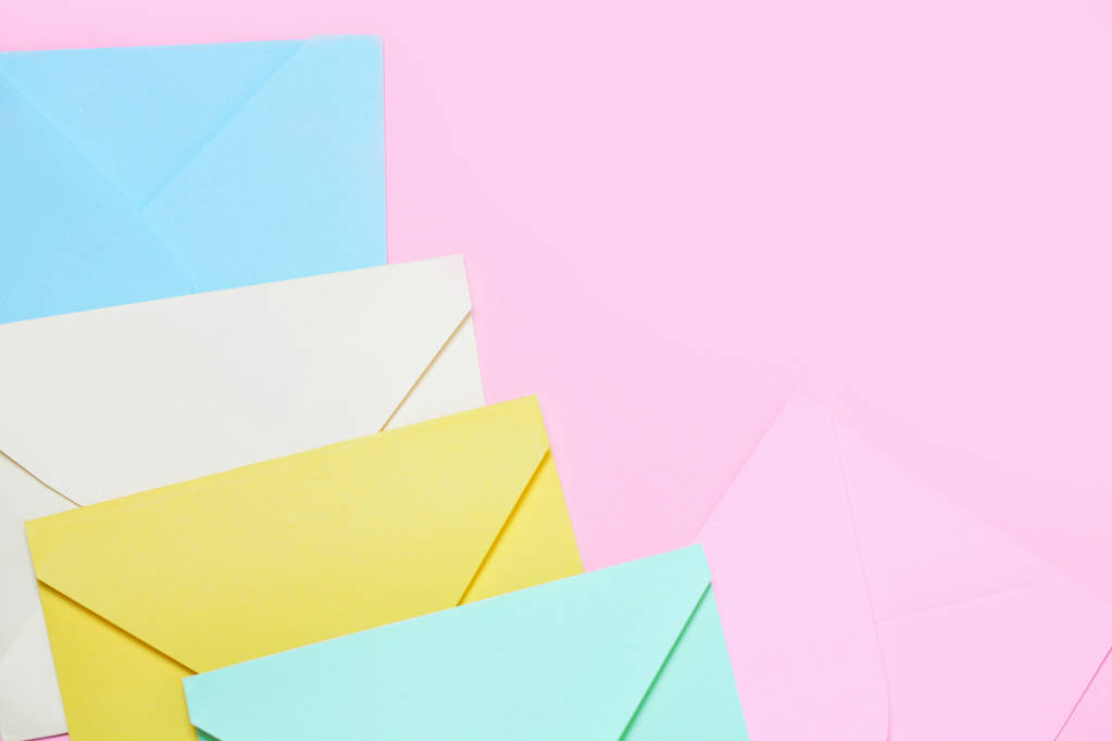 Frame from colorful envelopes on pink table top view. Mockup for business mail, blogging and office correspondence. Flat lay. - Photo, Image