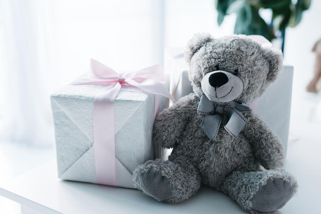 selective focus of teddy bear with gift boxes on table  - Photo, Image