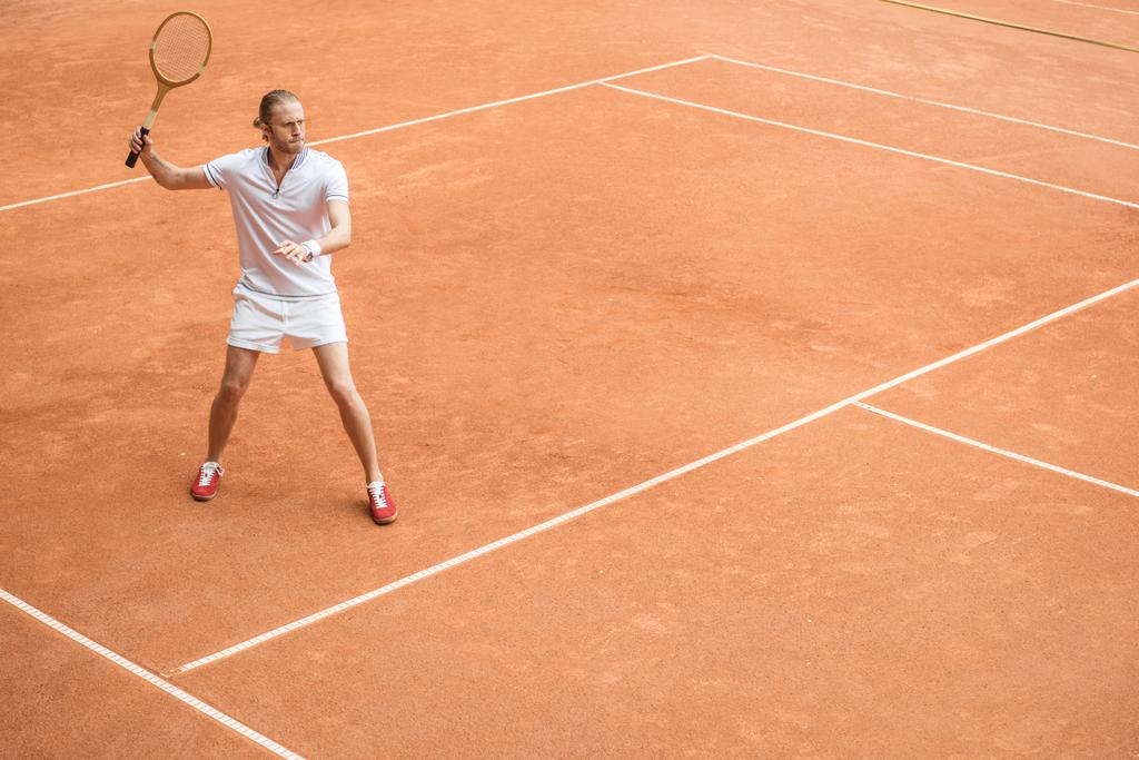 retro styled tennis player with racket on tennis court - Photo, Image