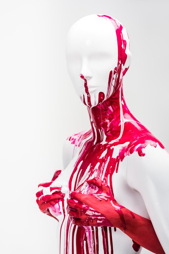 abgeschnittene Bild von Mädchen in roter Farbe berühren Schaufensterpuppe Brüste isoliert auf weiß - Foto, Bild