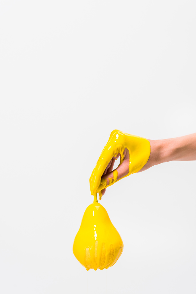 image recadrée de femme en peinture jaune tenant la poire à la main isolée sur blanc
 - Photo, image