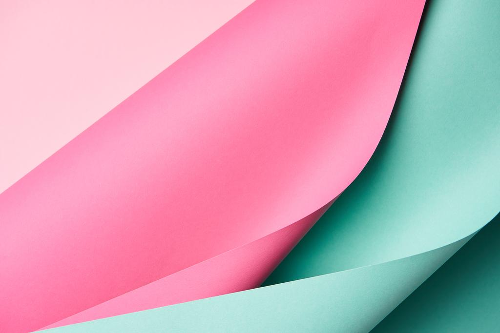 vergrote weergave van heldere turquoise en roze gekleurd papier textuur achtergrond   - Foto, afbeelding